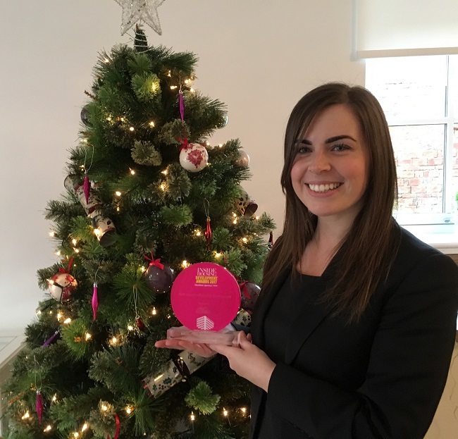 Laura Burns, sales consultant, with the award
