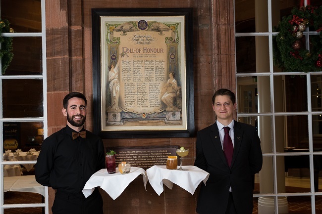 Waldorf Astoria staff in Edinburgh in front of the restored Roll of Honour, with cocktails which will raise funds for veterans' charities