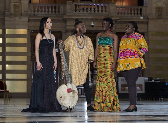 Artist Naa Densua Tordzro (right), Senanu Tordzro (second from right) and niece Linda Tordzro (left) wearing another traditional Africian outfit also on show. They are joined by son Setor playing the kora. 