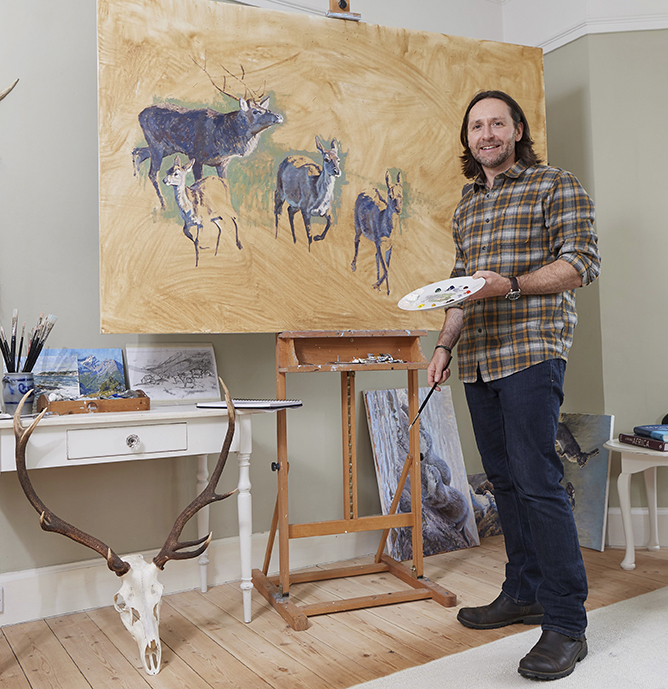 Justin Prigmore painting in his studio.