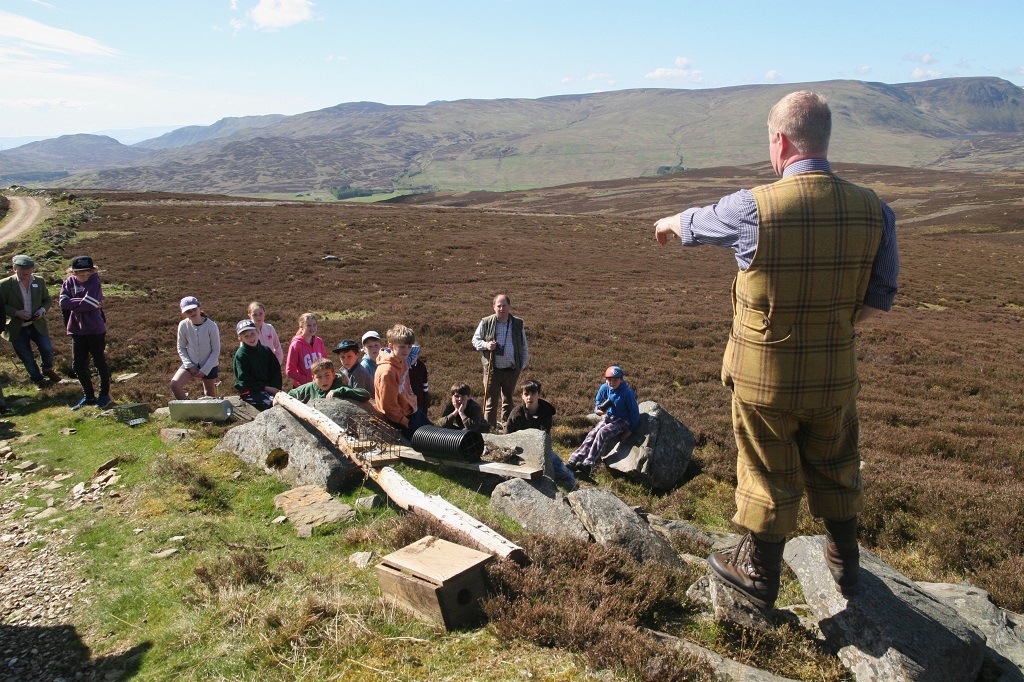 A gamekeeper demonstrates legal predator control tools to school children. The control of abundant predators has helped protect black grouse populations and rare wading birds in Perthshire. (Photo: Tayside &amp; Central Scotland Moorland Group)