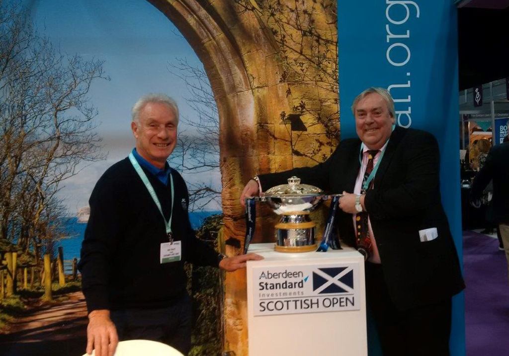 VisitScotland chief executive Malcolm Roughead  (right) gets his hands on the Scottish Open trophy