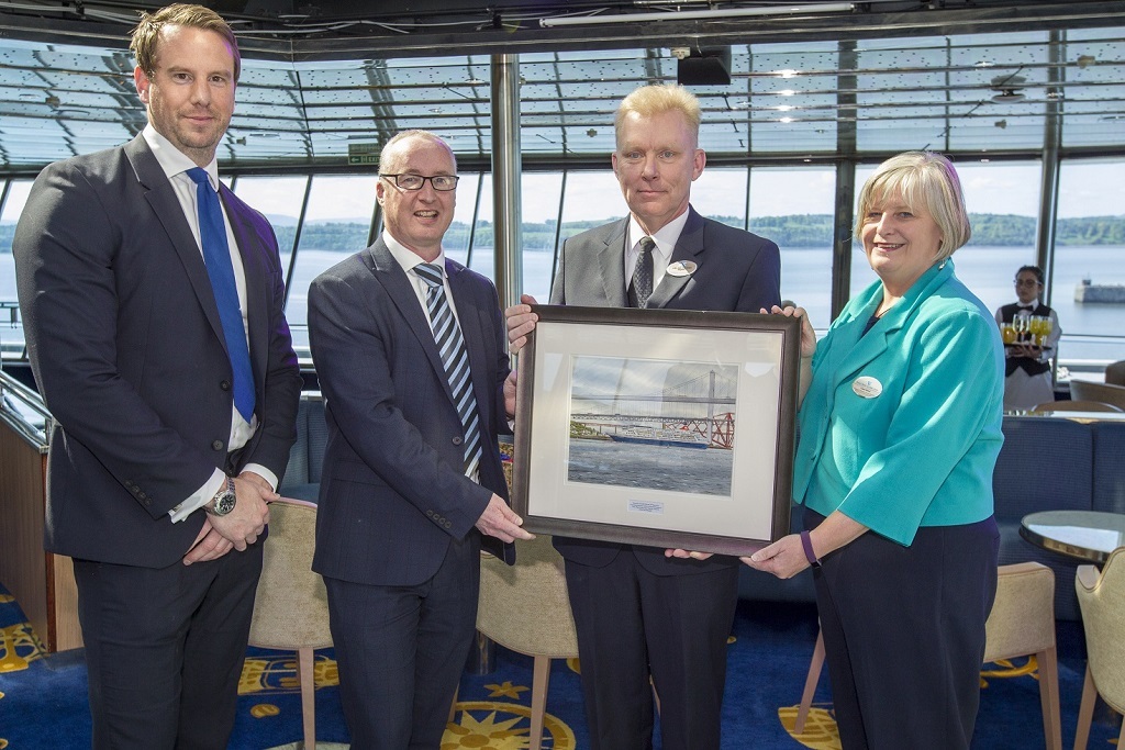 Captain Lars Kjeldsen, Master of Fred. Olsen Cruise Lines’ flagship Balmoral (second from right), presents Stuart Wallace, Chief Operating Officer of Forth Ports (second from left), with a special commemorative painting of Balmoral at a VIP Reception on board in the Port of Rosyth, along with Fred. Olsen’s Clare Ward, Director of Product and Customer Service, and Robert Mason, Capital Cruising’s Head of Cruise at Rosyth.  
(Photo: Peter Devlin)