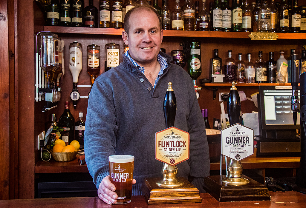 Murray Campbell behind the bar, with some of his produce