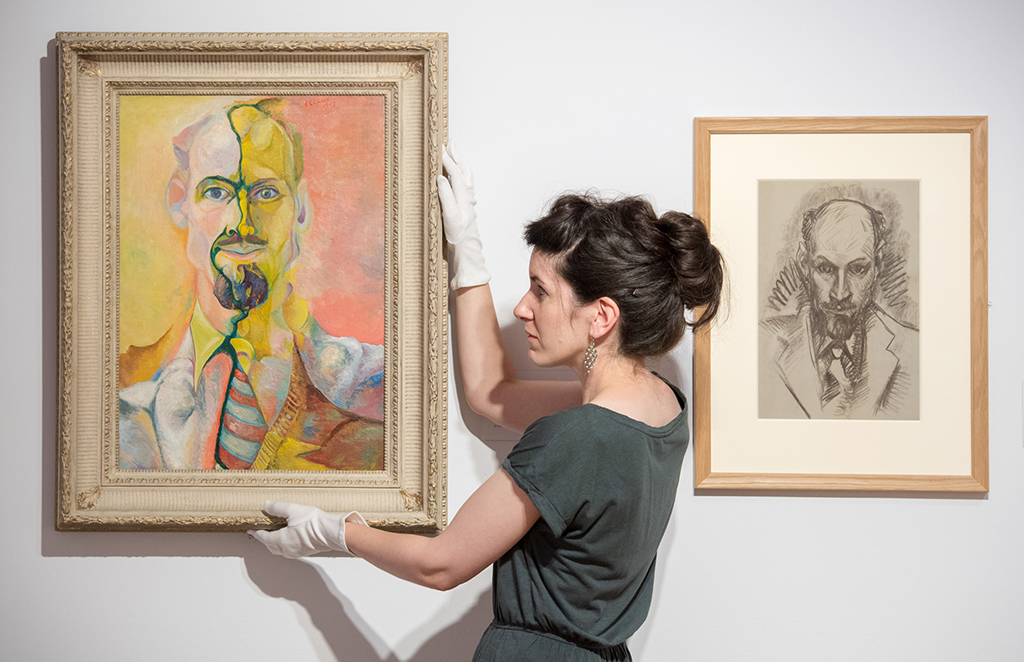 Curator Dr Helen Scott with 'Self Portrait' by Edwin G Lucas, from 1948  (Photo: Ian Georgeson)