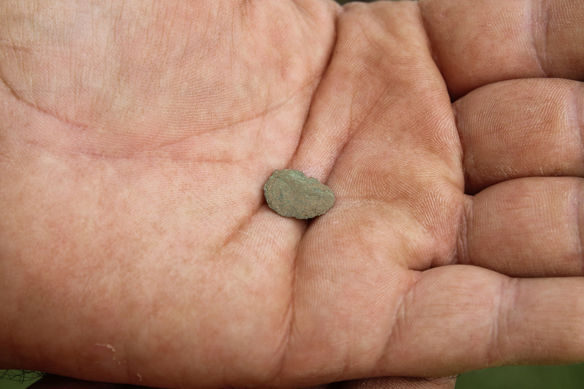 It might be hard to identify but this small artefact is a coin from the rein of Charles 1st and dates to 1632 - 1639