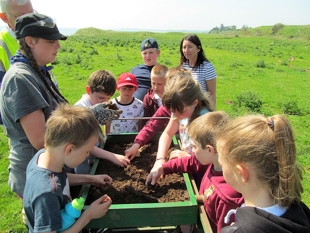 Brora Primary's P5 class looking at the sieving machine