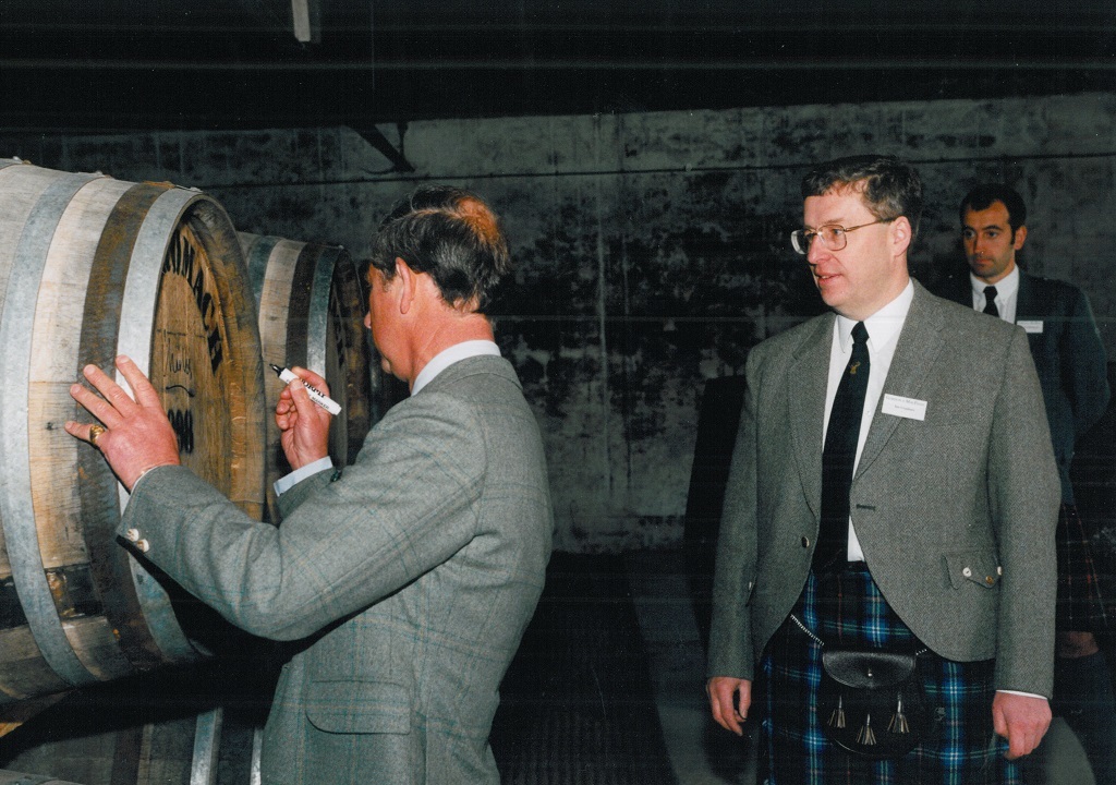 His Royal Highness The Duke of Rothesay at the reopening of Benromach Distillery in 1998. Image shows left to right: HRH The Duke of Rothesay signing Cask No 1, Ian Urquhart and Ewen Mackintosh (in background).