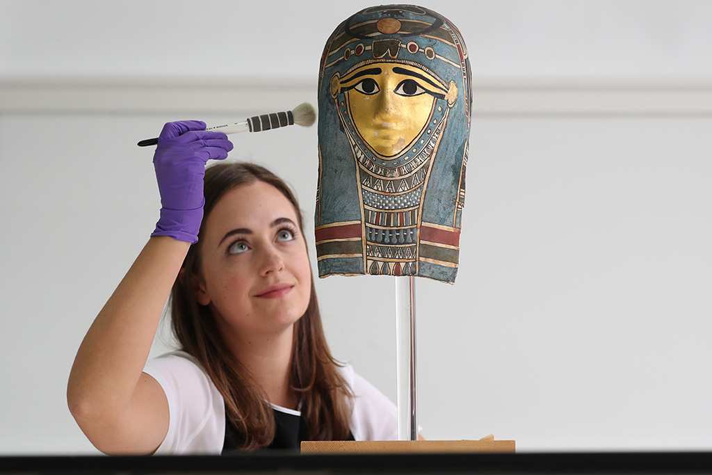 Assistant conservator Margot Murray works on a mummy mask (Photo: Stewart Attwood)