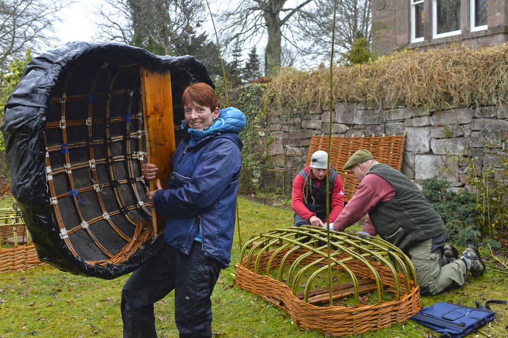 Jane Wilkinson carries her coracle (Photo: Angus Blackburn)