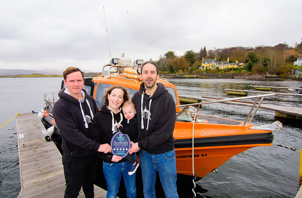 Head Guide Luke Saddler, Owners Nikki and Shane Wasik with Mara, of Basking Shark Scotland at their dive boat ‘Cearban’.