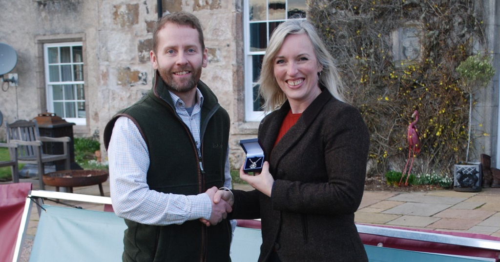 Tricia Schooling is presented with her prize by Jake Swindells from BASC