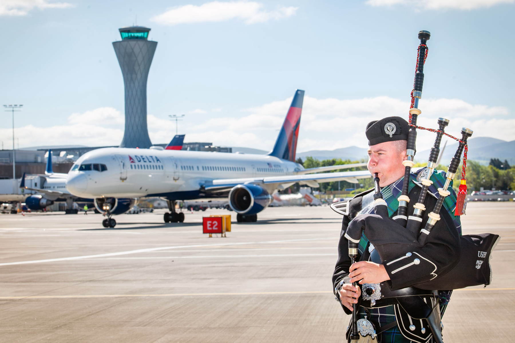 A piper sees off the inaugural flight between Edinburgh and Boston with Delta Air Lines 