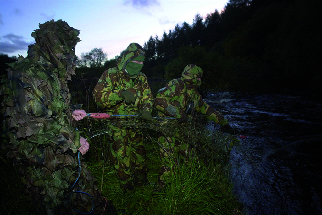 Members of a covert water bailiff team from  The Salmon Fisheries Protection Board who work under the cloak of darkness pulling in a net left by a poacher (Photo: Christopher Furlong)