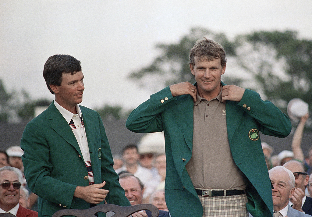 A smiling Sandy Lyle, right, is presented the Green Jacket of the Augusta National Golf Club after he won the 1988 Masters golf title