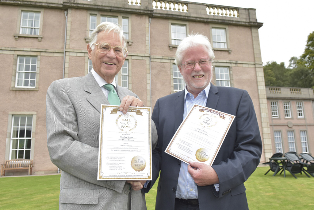 Professor Skene (left) receives the award for the most outstanding retirement community in the UK