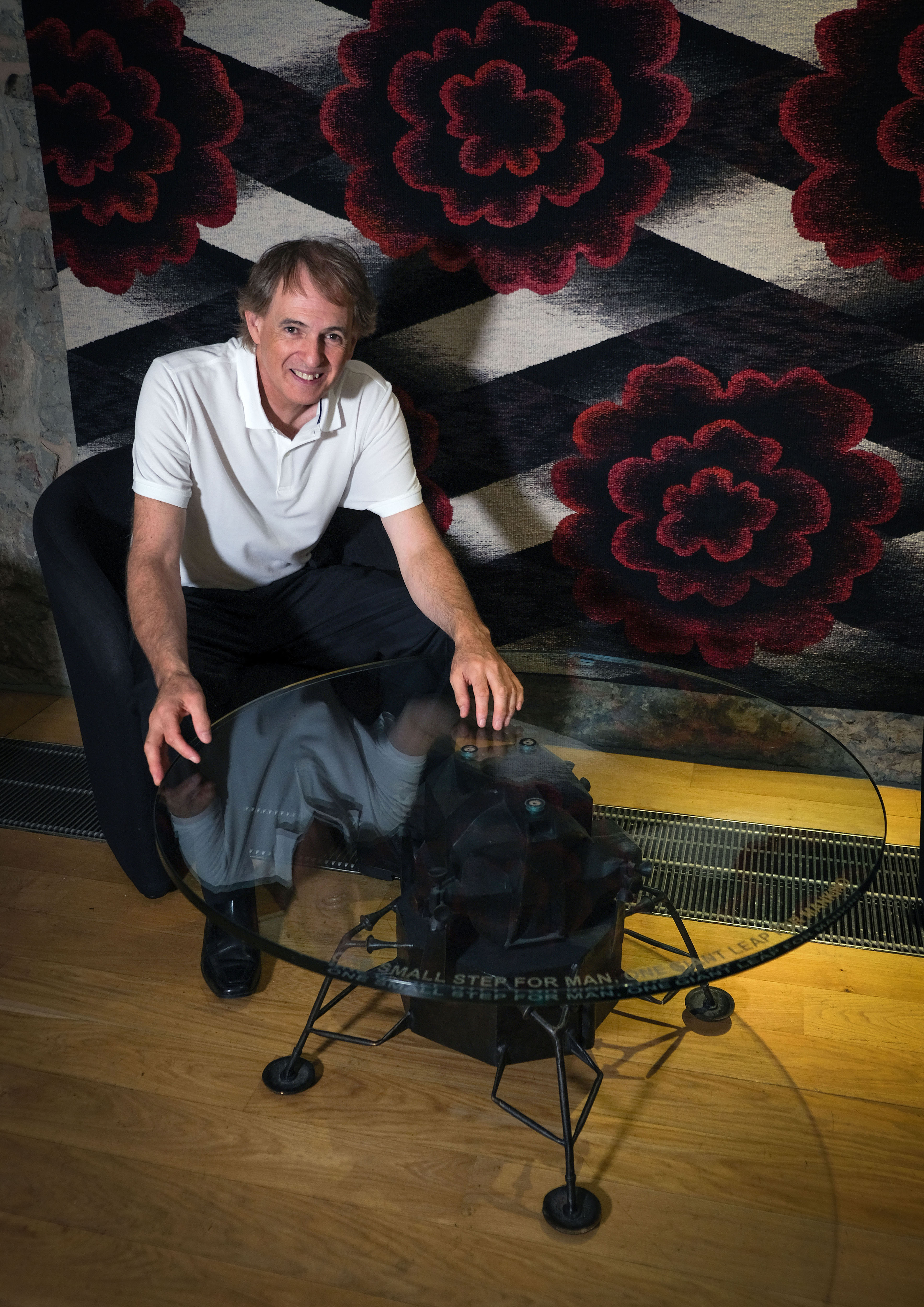 Artist and designer Mark Stoddart at Scottish Parliament with a one of his special tables