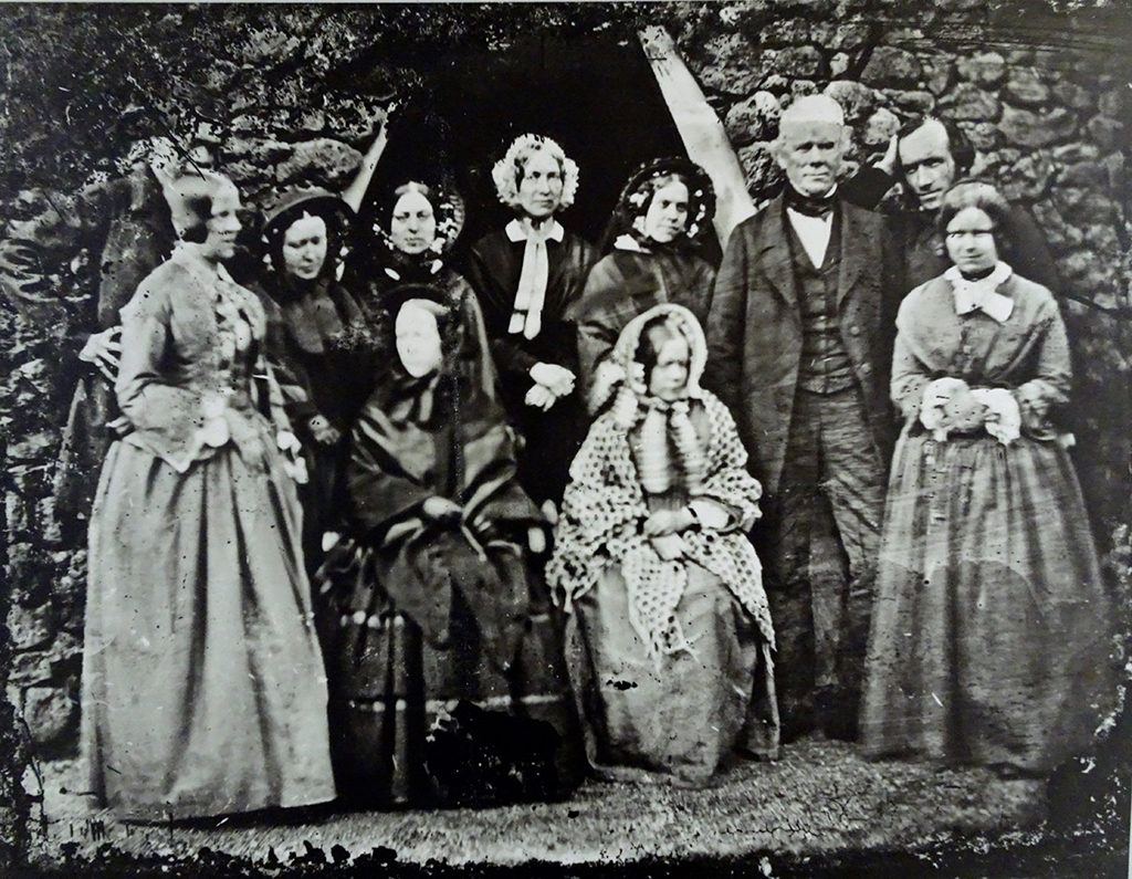A Cadell family group, with the white-haired man believed to be Hew Cadell and smoothing down his hair is his son Robert Cadell who took the photo - sorting his hair after sprinting to join the group!