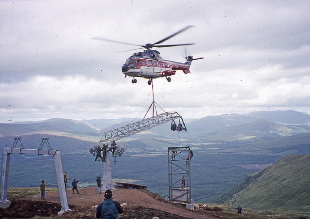 A helicopter helps in the construction of the Nevis Range gondola towers