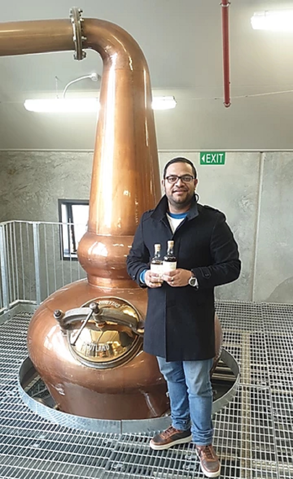 Ash Parmar with bottles from his own collection at Cardona Distillery