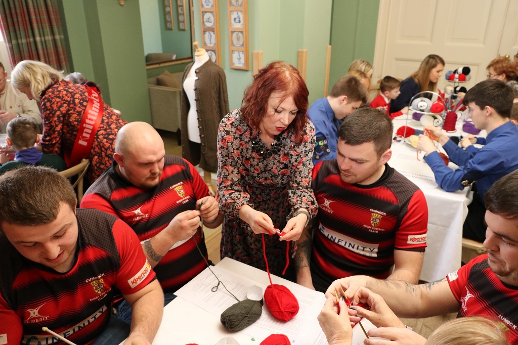 Jacqueline Farrell, education director at the Prince's Foundation, instructs members of Cumnock Rugby Club at the Sunday Sit and Knit 