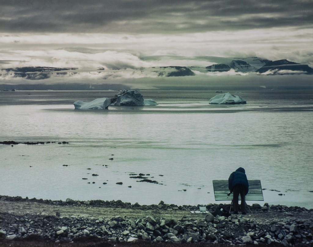 James Morrison painting at his easel in the Arctic