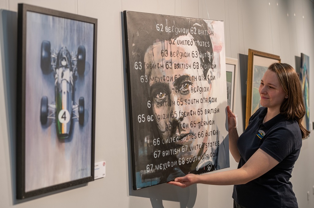 Yulia Tarasenko, pictured hanging one of the paintings called, Face of a champion, by Sean Wales (Photo: Phil Wilkinson)