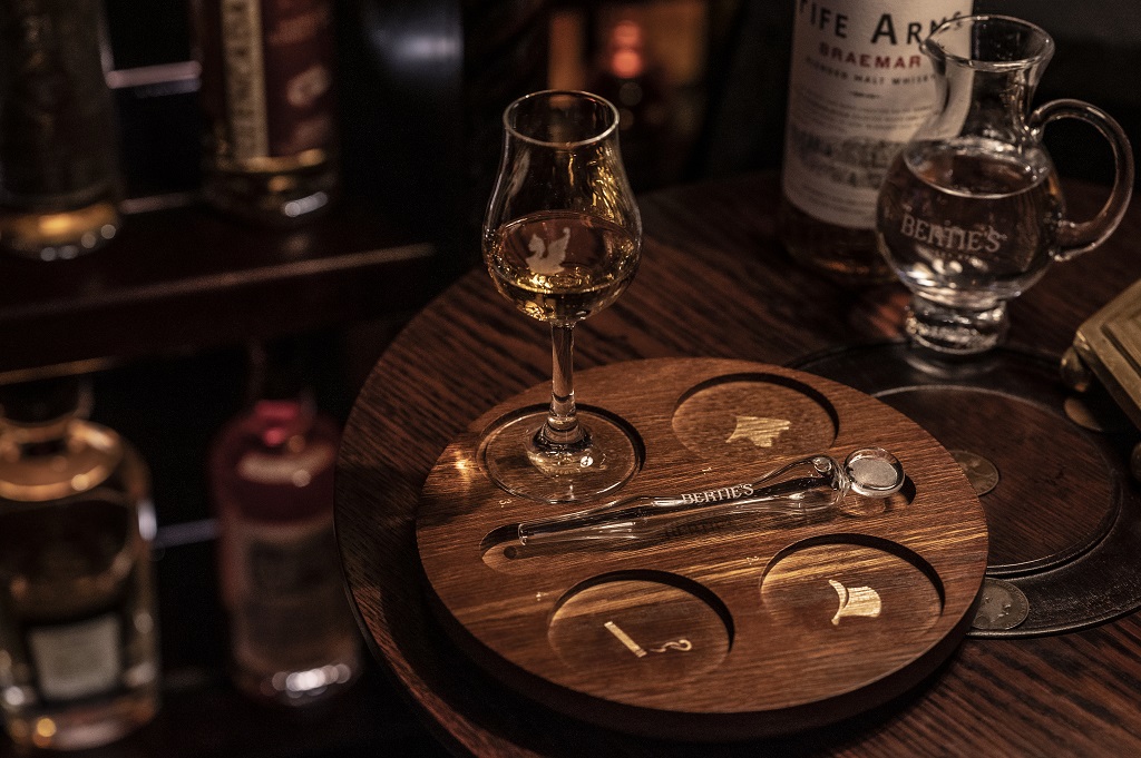 Choosing a dram at Bertie's Whisky Bar