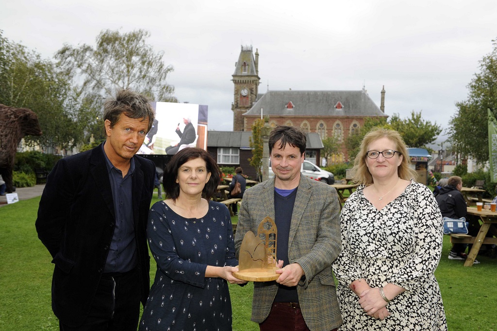 Anne Brown Essay Prize Winner Dani Garavelli (centre), with her trophy, with Anne Brown's son Richard Brown (left) and daughter Jo Lawrence, and director of Wigtown Book Festival Adrian Turpin (centre) - pictured in Wigtown  (Photo: Colin Hattersley)