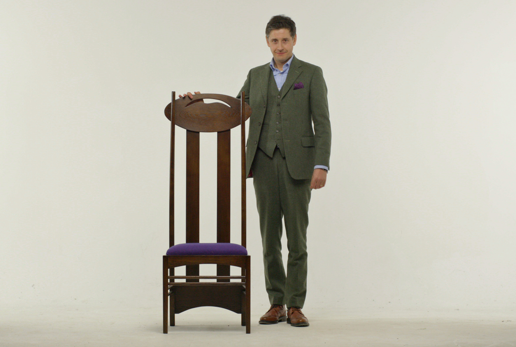 Programme Name: Mackintosh: Glasgow's Neglected Genius - TX: 05/06/2018 - Episode: Mack/tosh1 (No. n/a) - Picture Shows: Artist Lachlan Goudie with one of Charles Rennie Mackintosh's iconic chairs Lachlan Goudie - (C) BBC Studios - Photographer: BBC Studios