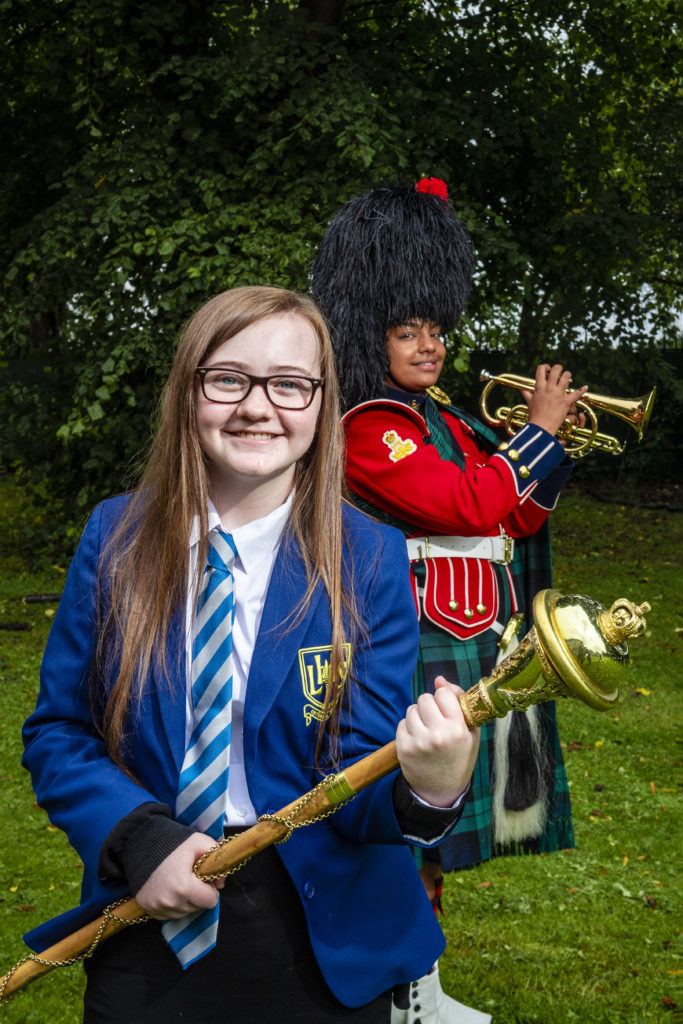 A 12-year-old school student had a huge surprise when she was taken to Redford Barracks and presented with a professional recording made by Army musicians of her rap inspired by the Windrush generation. 
Leila McPhate, from Larbert High School in Stenhousemuir, wrote The World Is A Dark Place as her entry for Never Such Innocence, an international arts competition to give children and young people a voice on conflict.
Leila, who has autism spectrum disorder (ASD), had learned at school how people from the Caribbean were invited to the UK to help it rebuild after WWII but frequently faced injustice and discrimination. After seeing the black British artist Dave on the Brit Awards she decided to address the issue with a rap.
The Army was among the supporters of the 2019/20 competition and Leila’s song caught the eye of Lieutenant Colonel Wendy Faux, the Army’s head of arts, who led the team behind this year’s three-week Army@TheVirtualFringe event.
She was so impressed that she arranged for the Countess of Wessex’s String Orchestra to create a new soundtrack for her rap. Leila was invited to the barracks where Colour Sergeant Richard Kerr, Musician Brittany Johnnie and Corporal Scott MacFarlane of the Band of the Royal Regiment of Scotland presented her with flowers and a copy of the music on behalf of the Army.
Wendy said: “Army@TheVirtualFringe has shone a light on many issues including racism and equality. We have also been trying to support young and emerging talent. So working with Leila has been a perfect way to round off the event.  
“The contribution of people from Commonwealth nations in Africa and the Caribbean to the Army and to civilian life has been immense but is often overlooked, along with the discrimination so many of them experienced.
“The fact that young people like Leila are determined to use their talents to demand a better world gives real hope for the future.
“We are really proud to have been able to bring her together with some s