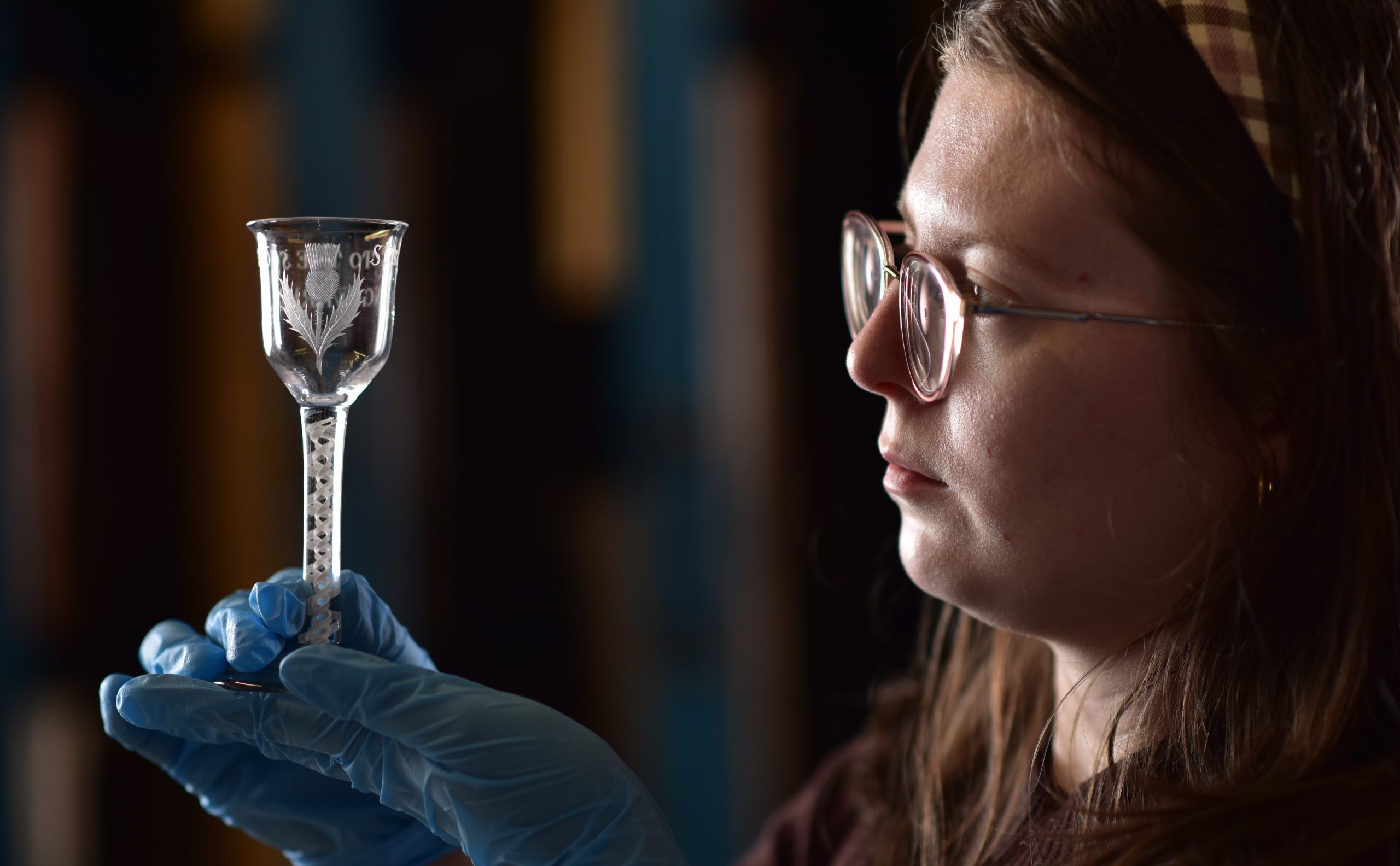 Lucy-Brayson-Collections-Assistant-at-Perth-Museum-holds-an-18th-century-Jacobite-Glass.-Photo-Julie-Howden-1-24byckval-scaled