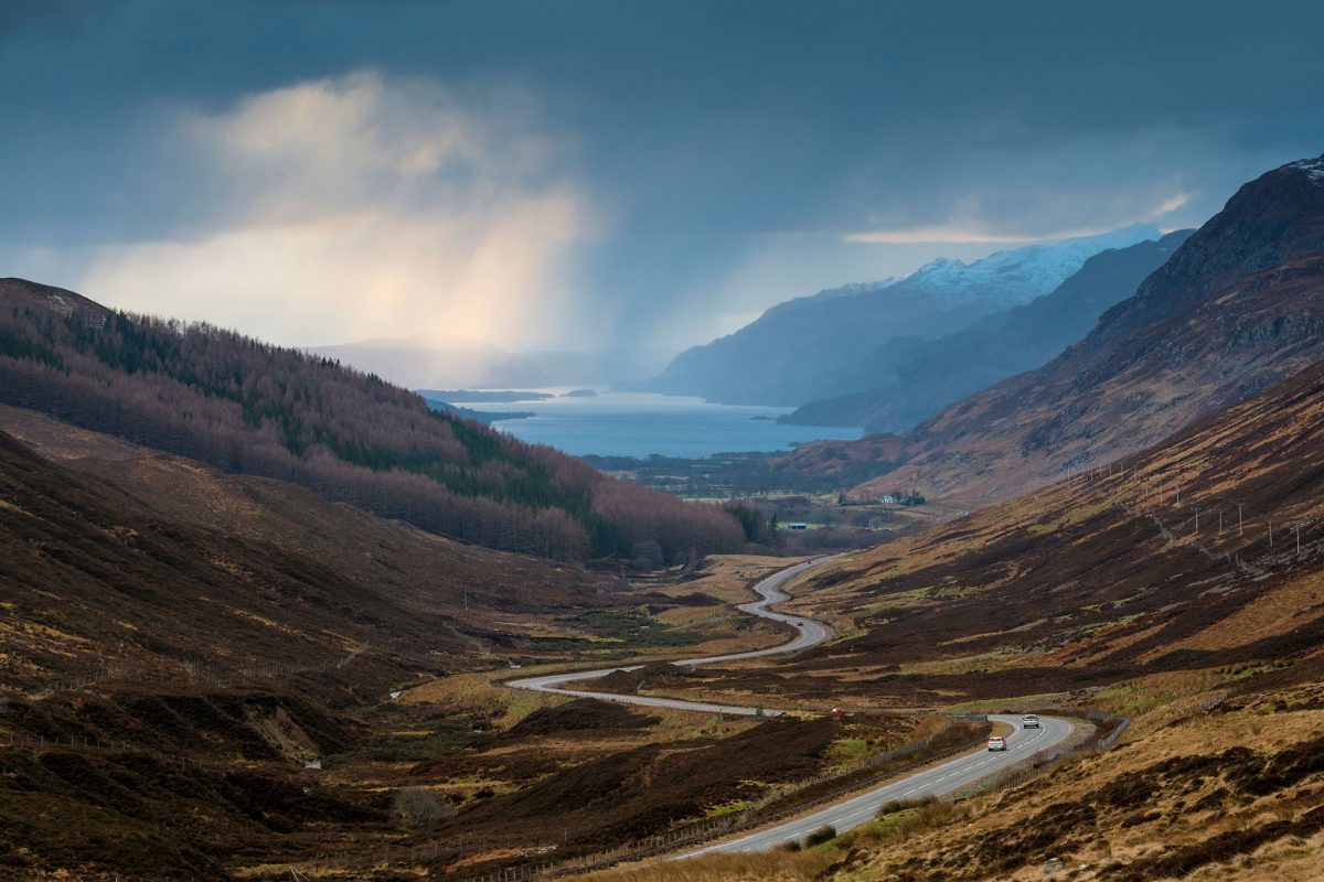 The-road-to-Kinlochewe-with-Loch-Maree-beyond-part-of-the-North-Coast-500-1200x800