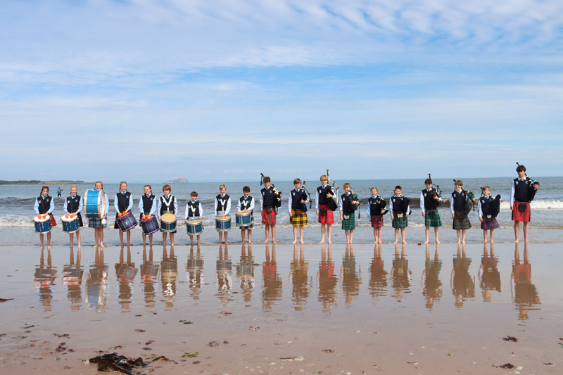Belhaven Hill School - pipers on a beach