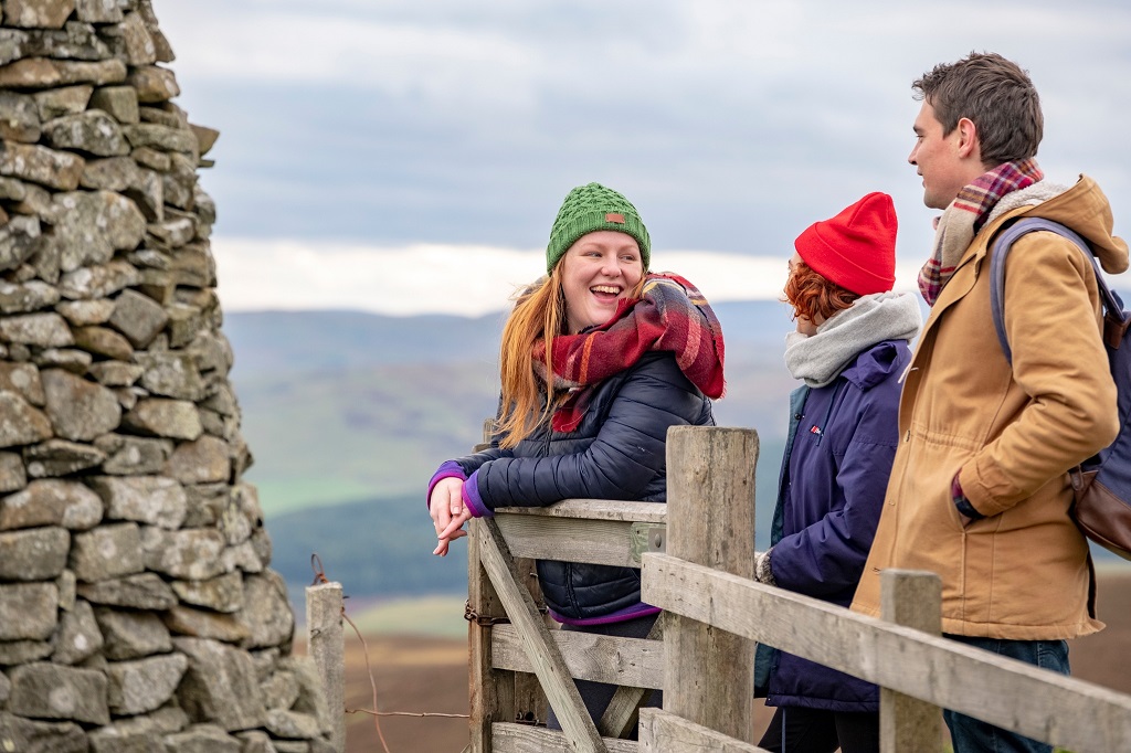 Three friends walk the route to The Three Brethren
cairns on the Southern Upland Way Scottish Borders