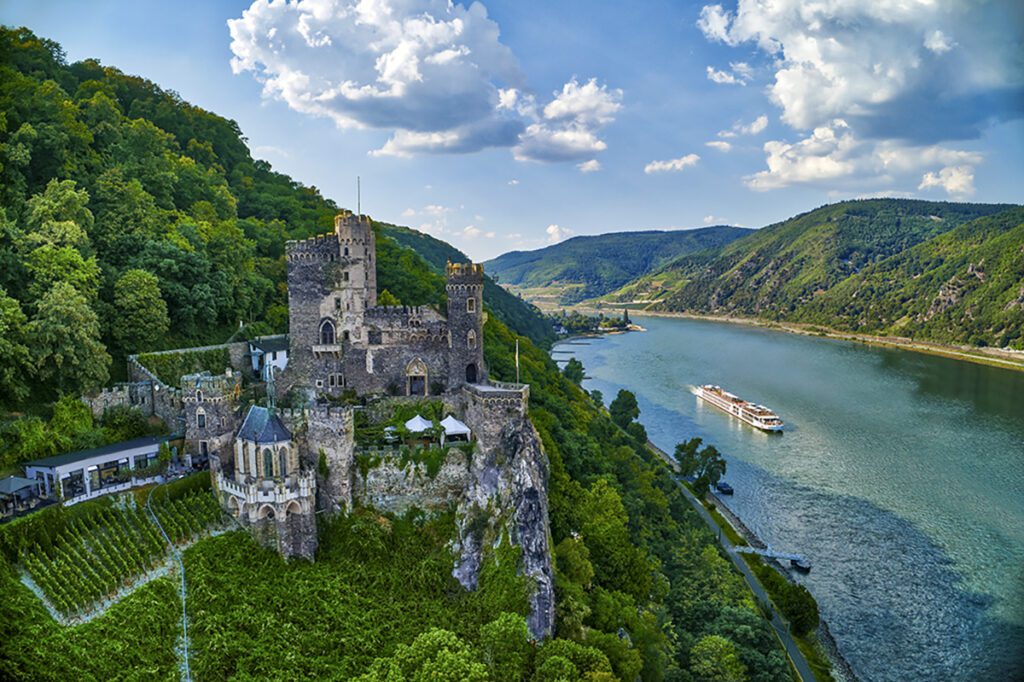 Viking longship on the Rhine River passing Rheinstein Castle, near the town of Trechtingshausen. [Viking]