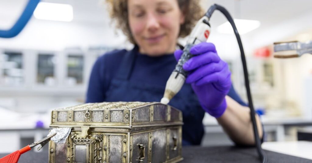 Conservator Diana de Bellaigue removes tarnish from the Mary, Queen of Scots casket. Credit: Duncan McGlynn 