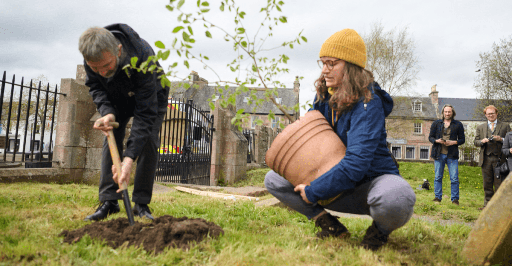 Dr Max Coleman and Emma Beckinsale (RBGE), plant one of the two new wych elm saplings. This sapling was recovered from the site of the Beauly Wych Elm after the tree fell early last year and is thought to have come from the ancient tree.