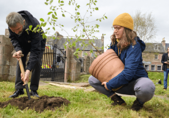 Dr Max Coleman and Emma Beckinsale (RBGE), plant one of the two new wych elm saplings. This sapling was recovered from the site of the Beauly Wych Elm after the tree fell early last year and is thought to have come from the ancient tree.