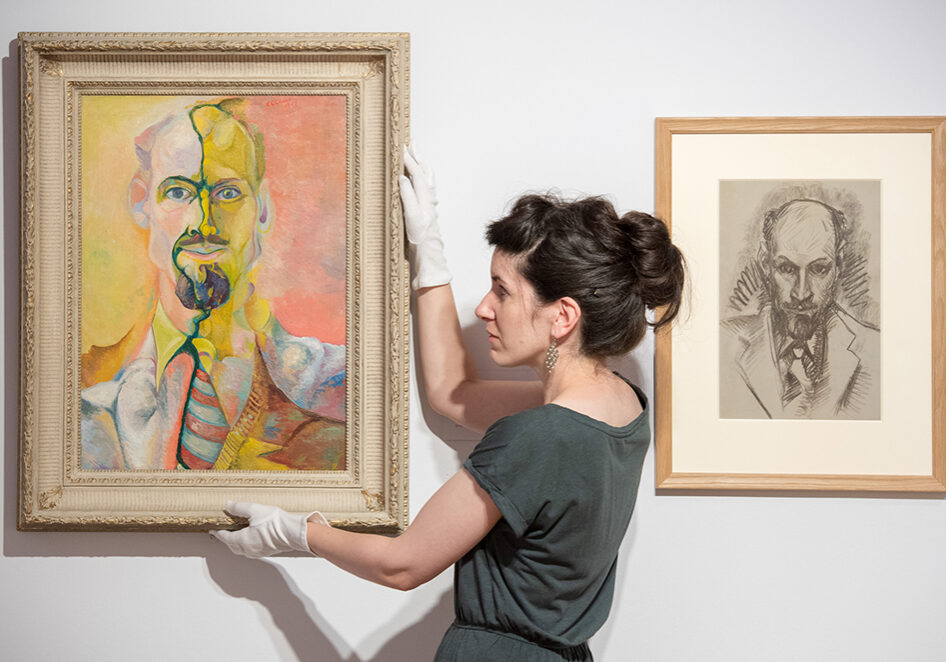 Curator Dr Helen Scott with 'Self Portrait' by Edwin G Lucas, from 1948  (Photo: Ian Georgeson)
