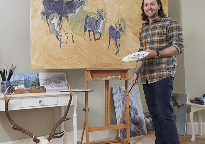 Justin Prigmore painting in his studio.