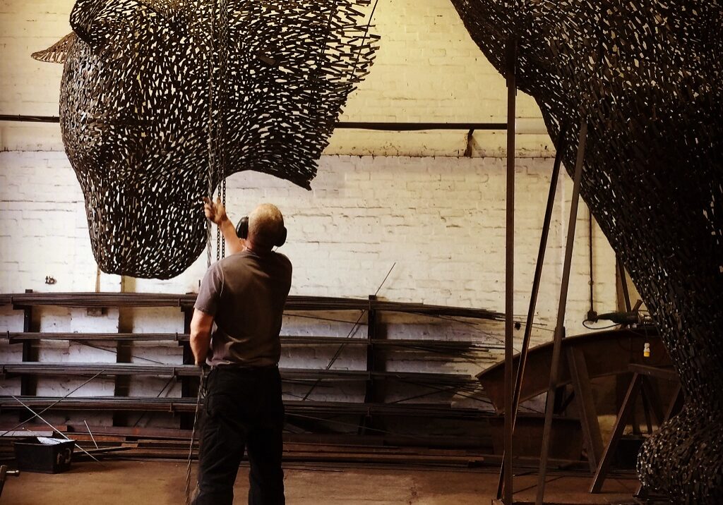 Andy Scott at work on 'Poised' in his studio 