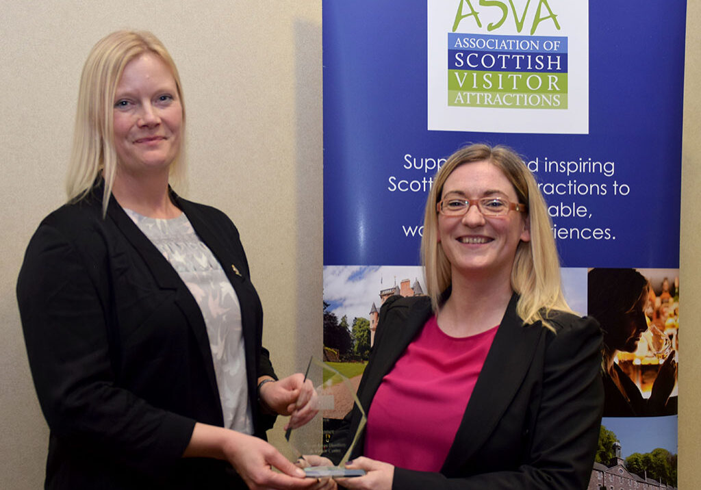 Tamsin Job, The Royal Yacht Britannia, presents the 2018 ASVA Best Visitor Experience Award to Jaclyn McKie, Isle of Arran Distillery and Visitor Centre