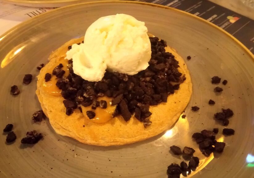 A protein pancake with peanut butter sauce, Oreos and coconut ice cream