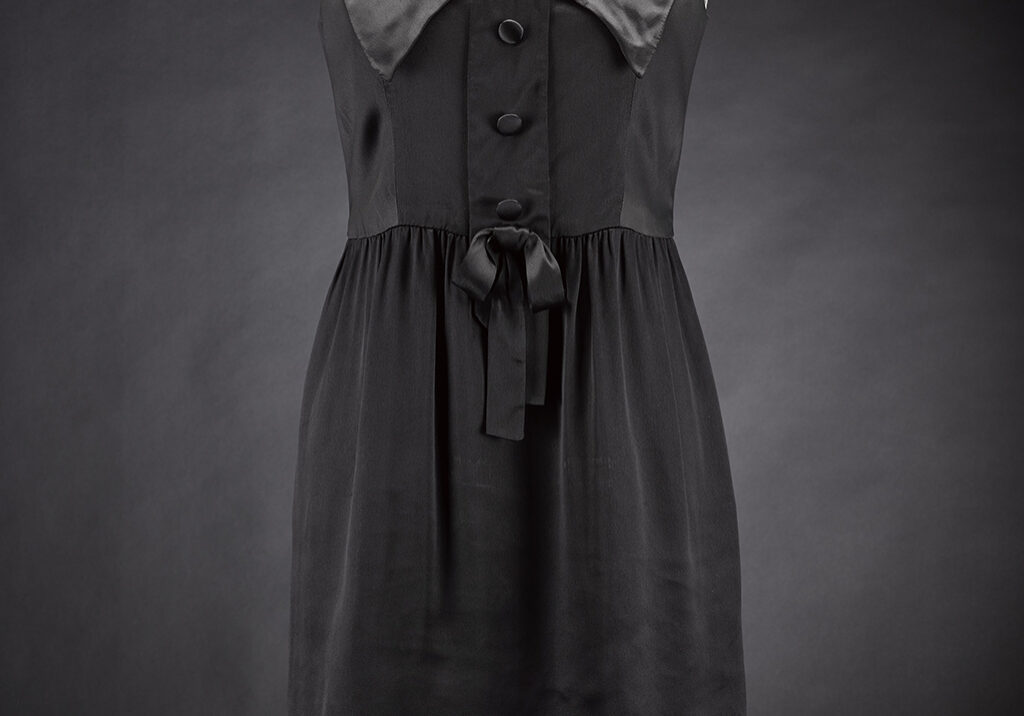 A black satin dress, worn and owned by Joanna Lumley, designed by Jean Muir, c. 1964