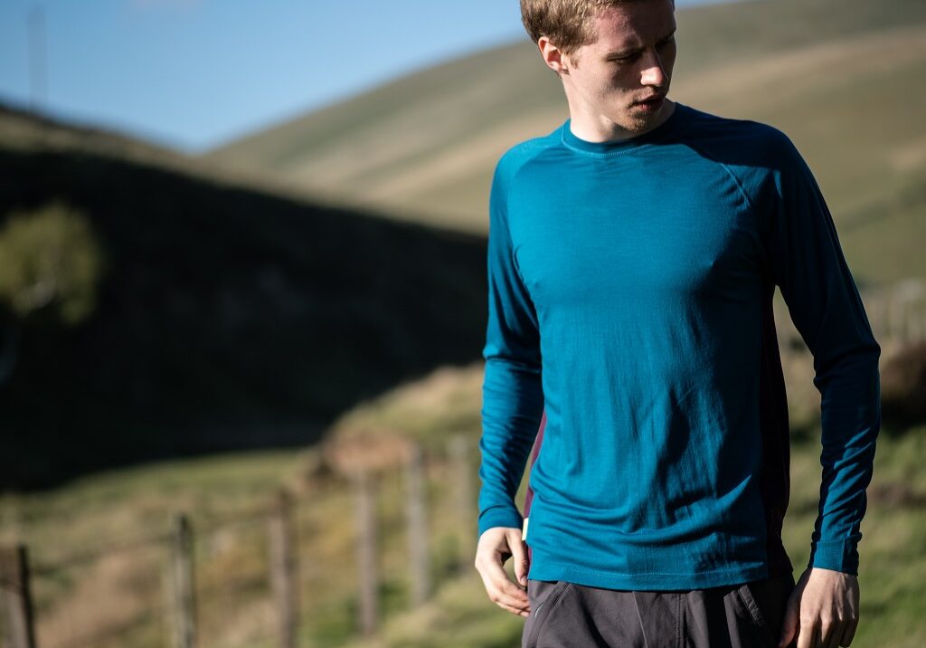 The FINDRA merino lite long sleeve top in loch blue 