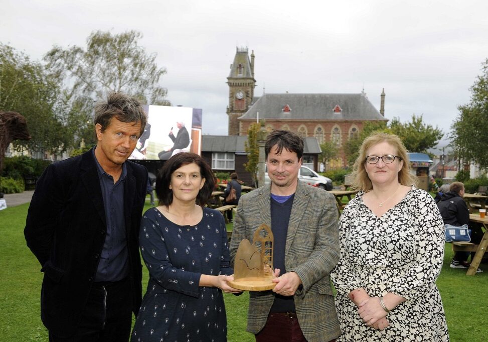 Anne Brown Essay Prize Winner Dani Garavelli (centre), with her trophy, with Anne Brown's son Richard Brown (left) and daughter Jo Lawrence, and director of Wigtown Book Festival Adrian Turpin (centre) - pictured in Wigtown  (Photo: Colin Hattersley)