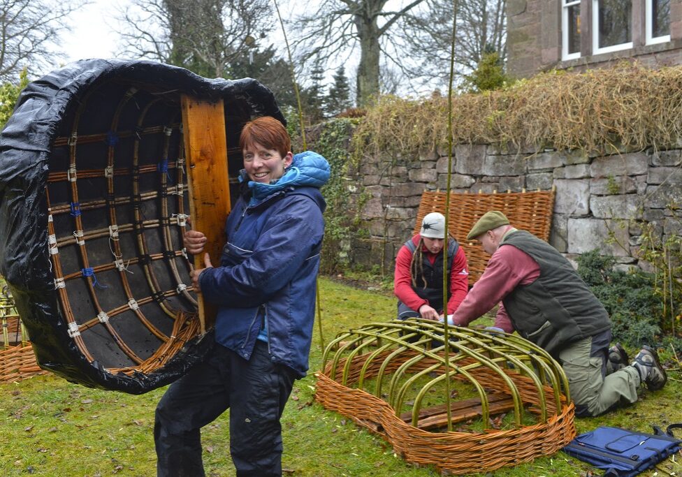 Jane Wilkinson carries her coracle (Photo: Angus Blackburn)