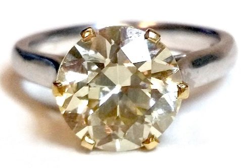 An impressive certificated yellow diamond solitaire ring