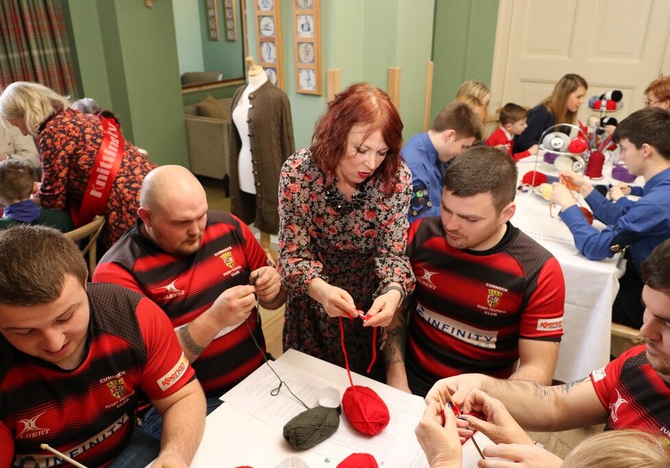 Jacqueline Farrell, education director at the Prince's Foundation, instructs members of Cumnock Rugby Club at the Sunday Sit and Knit 